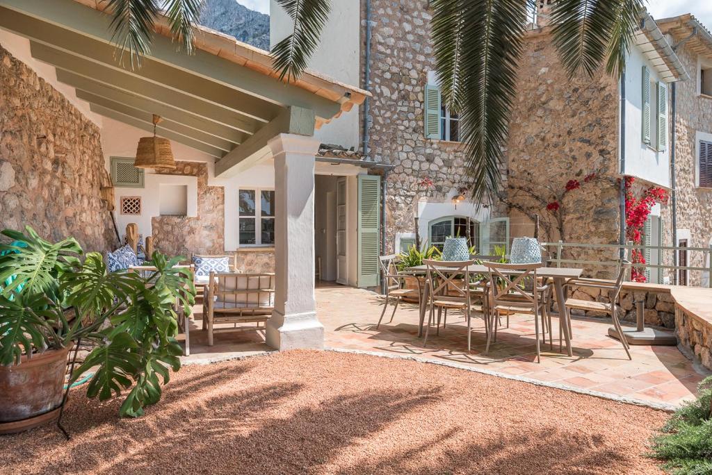 a patio with a table and chairs and a building at Ca Sa Padrina in Sóller