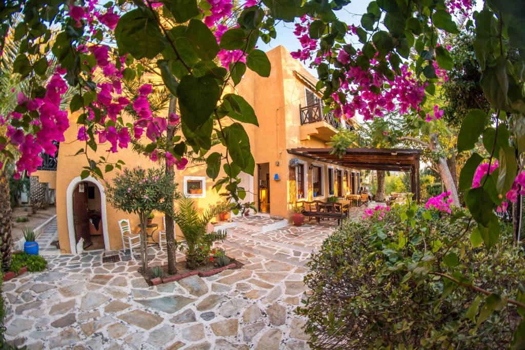 a courtyard of a house with purple flowers at Vagia Traditional in Vaia