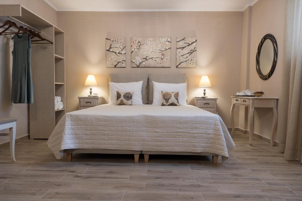 a bedroom with a large bed with two pillows at V. P. Place. in Argostoli
