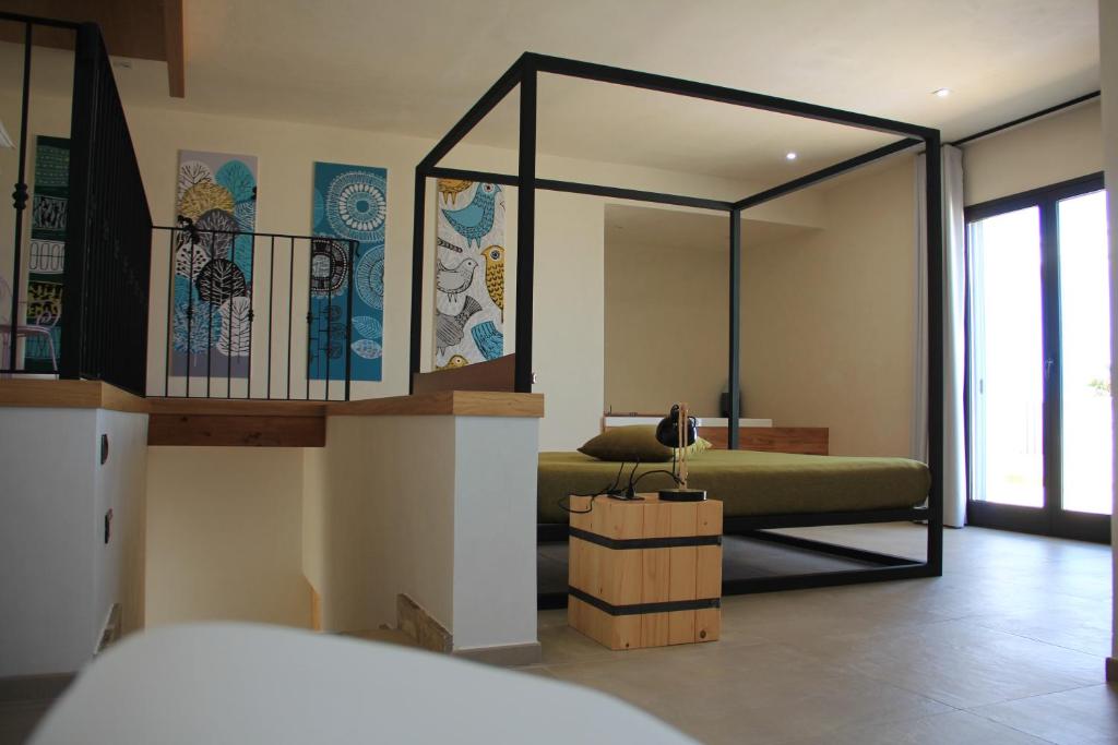 Postel nebo postele na pokoji v ubytování Punta Bianca Suite & Home Experience