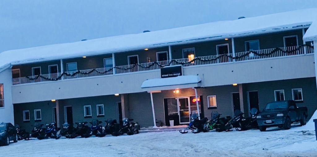 a group of motorcycles parked in front of a building at Wheel Inn Motel in New Liskeard