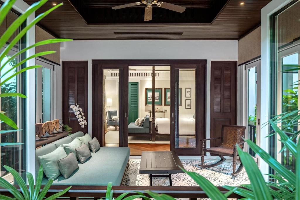 a living room with a couch and a bedroom at 137 Pillars House in Chiang Mai