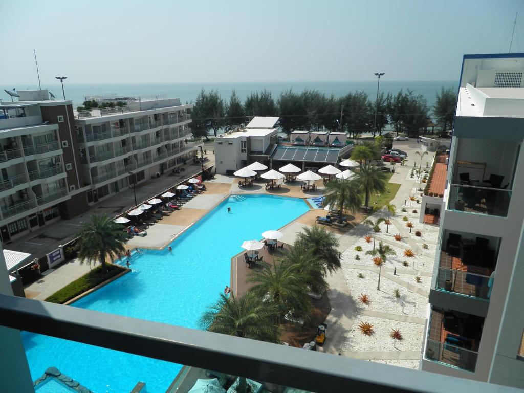 a view of a pool from the balcony of a hotel at Grandblue condominium 609 in Mae Pim