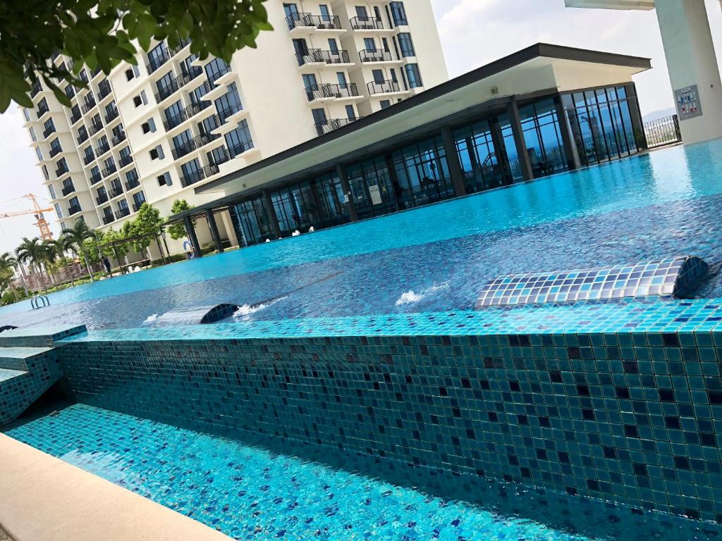 a swimming pool in front of a building at TREFOIL, WEE 816 STUDIO in Setia Alam