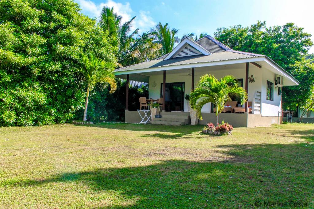 ein kleines Haus mit einem Hof davor in der Unterkunft Surf Tropical Villa Takamaka in Île au Cerf