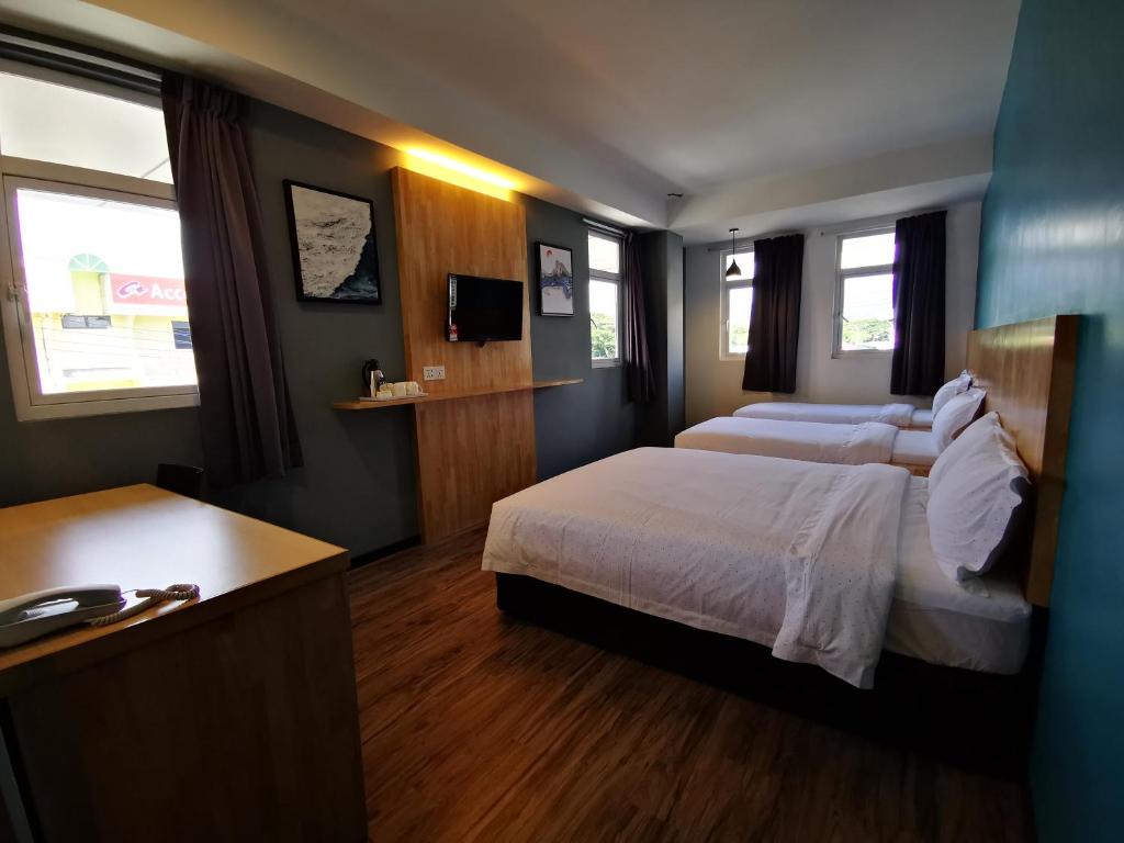 Postel nebo postele na pokoji v ubytování 3-Plus Hotel