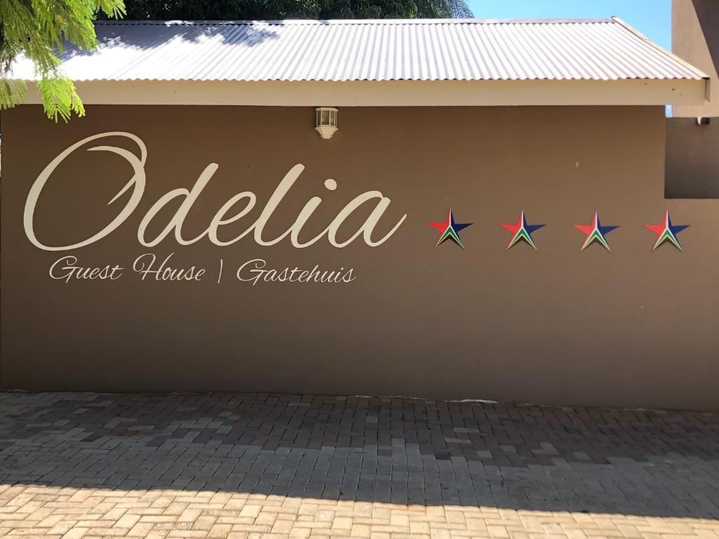 a sign on the side of a building with four stars at Odelia Guest House in Mokopane