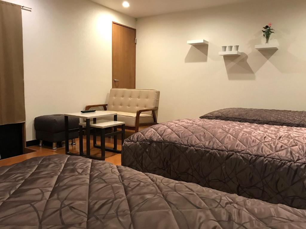 Postel nebo postele na pokoji v ubytování E Hotel Warabi