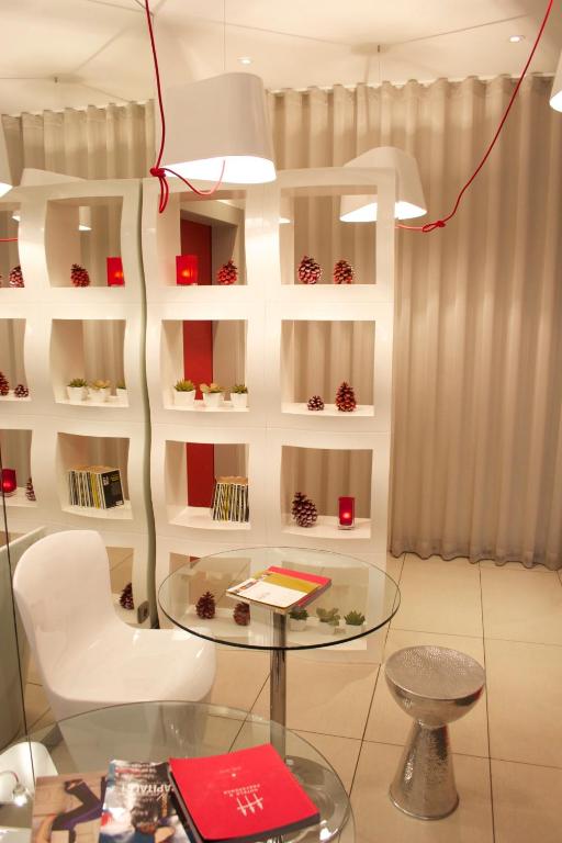 a room with a glass table and a chair at Villathena in Paris