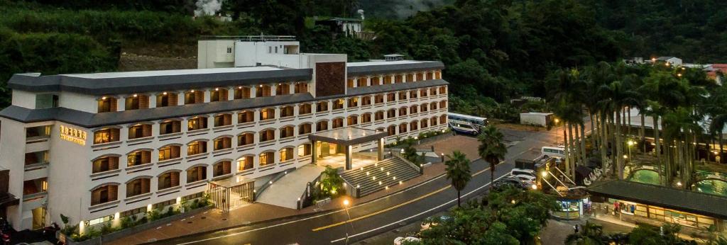 a large building on a city street at night at Dong Tair Spa Hotel in Wenquan