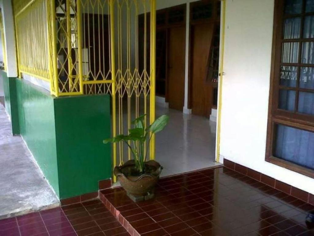 a plant in a pot on the floor of a building at Griya Palayu in Bogor