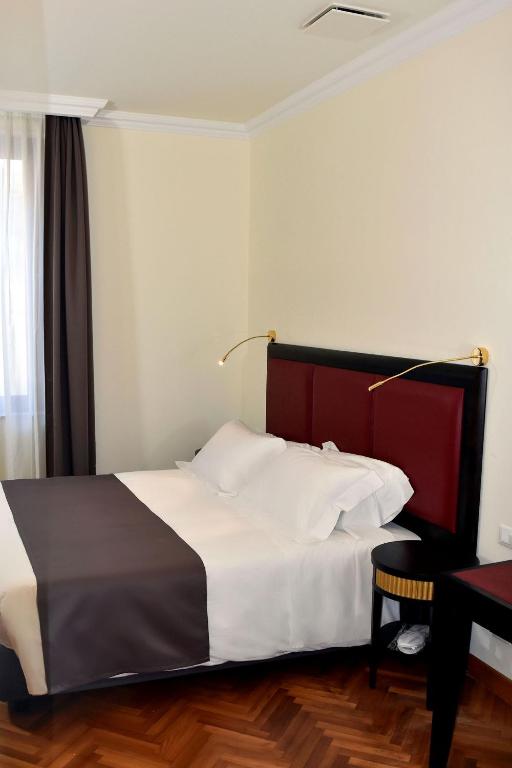 Postel nebo postele na pokoji v ubytování Torrione Hotel