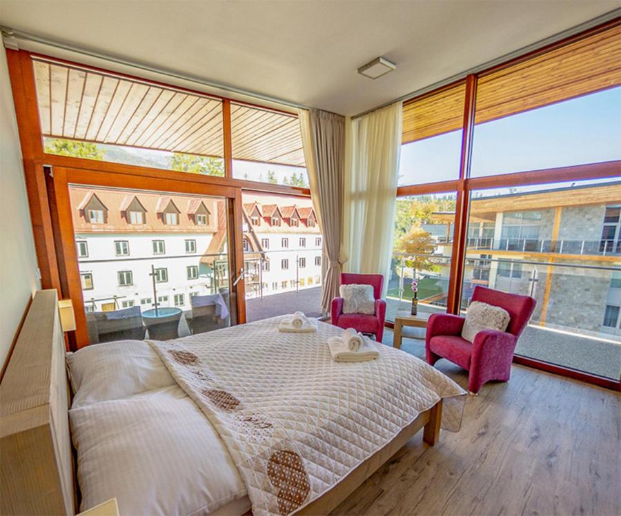 A bed or beds in a room at Apartmány Tatry