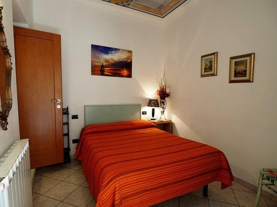 a bedroom with a bed with an orange blanket at Ninin Vernazza in Vernazza
