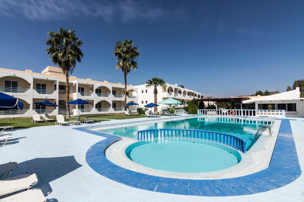 a large swimming pool in front of a hotel at Tivoli Hotel in Faliraki