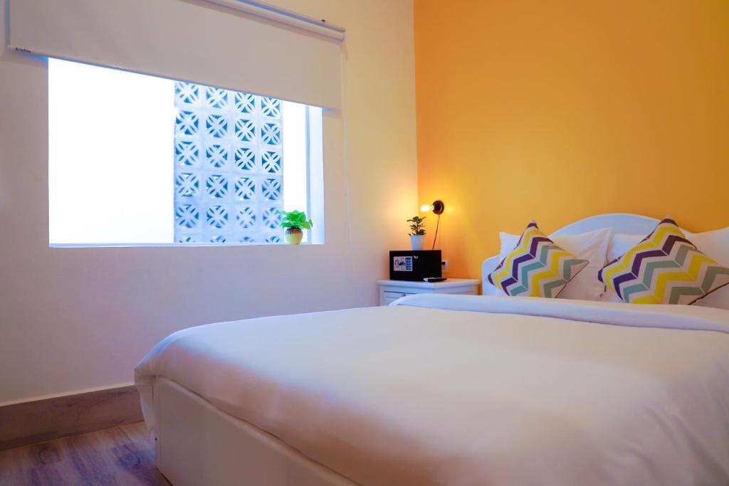 Postel nebo postele na pokoji v ubytování Glow Inn Siem Reap