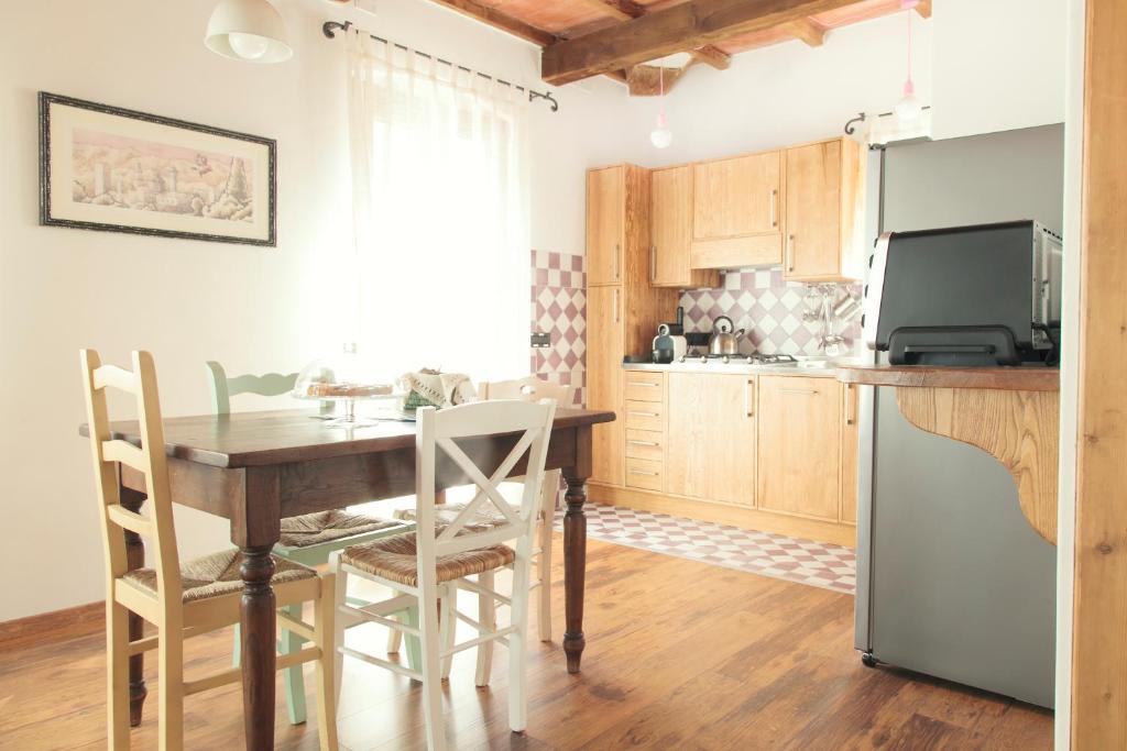 una cucina con tavolo in legno e una sala da pranzo di Casetta in Centro a Città di Castello