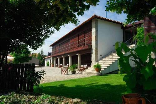 a large building with stairs and a grass yard at Quinta do Mosteiro in Felgueiras