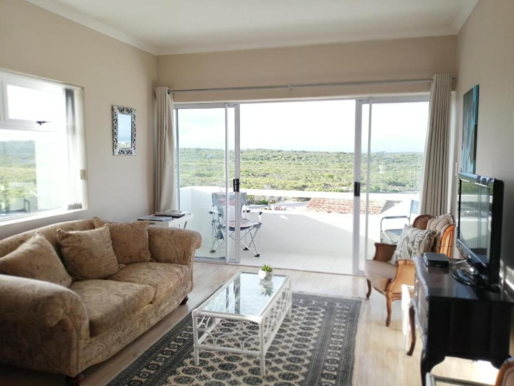 a living room with a couch and a table at Top Deck in Struisbaai