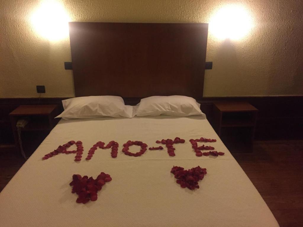 una cama con rosas en ella con la palabra amertes en ella en Xango, en Oporto