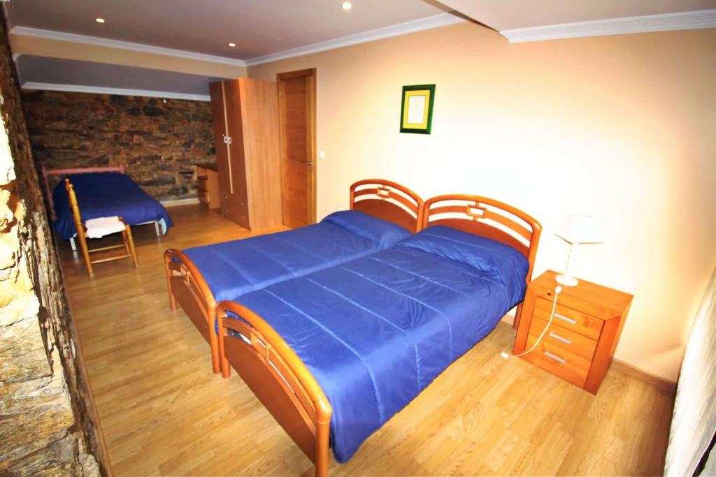 Postel nebo postele na pokoji v ubytování Casa Embalse da Fervenza