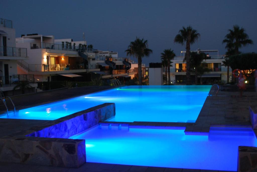 a swimming pool at night with blue lights at Egeo 3011 in Los Altos