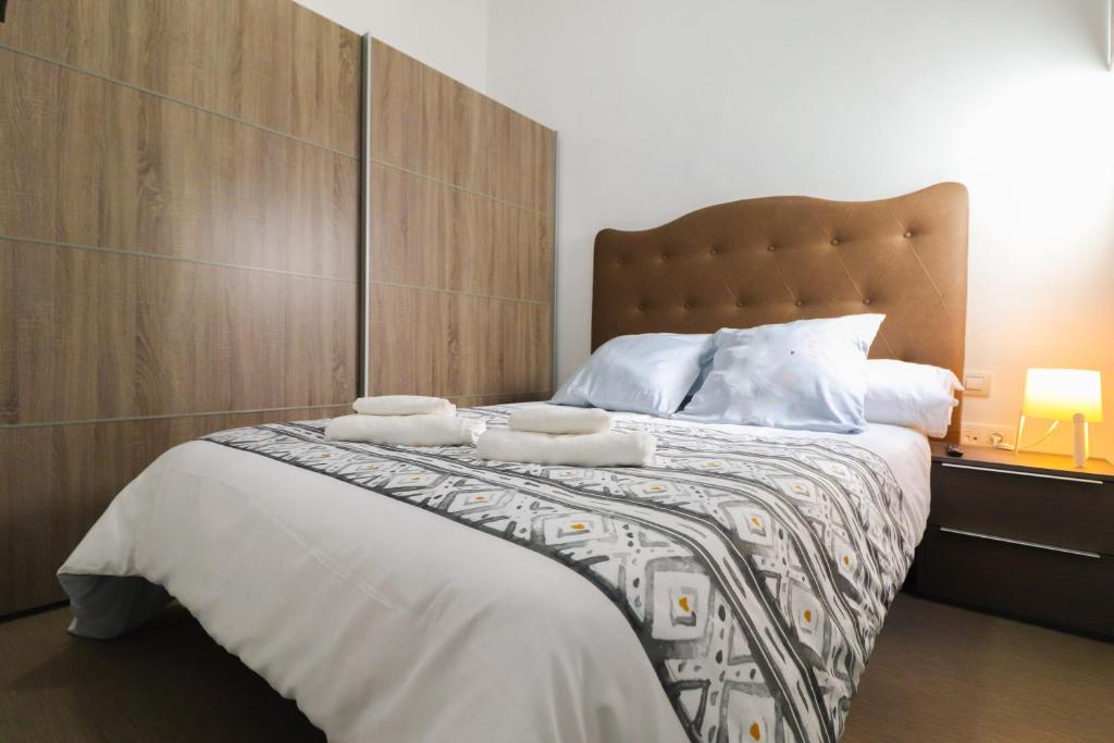 a bedroom with a bed with two towels on it at Apartamentos Bello Tenerife in Santa Cruz de Tenerife