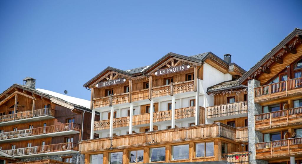 a hotel with wooden balconies on the side of a building at Le Paquis in Tignes