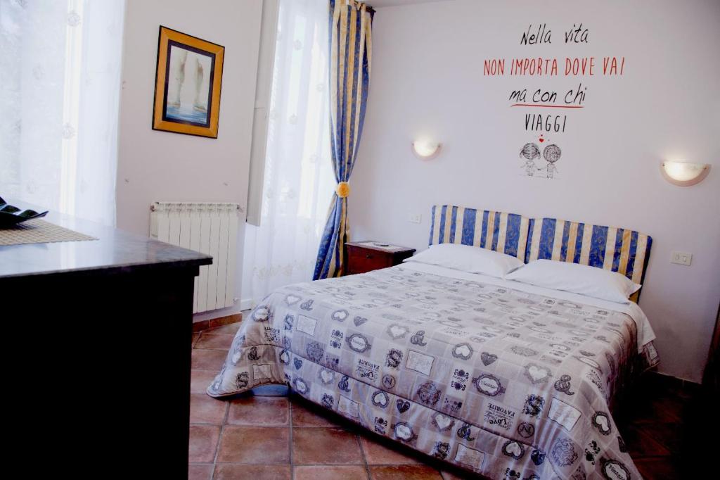 a bedroom with a bed with a comforter on it at B&B Metamorphosi in Fiuggi