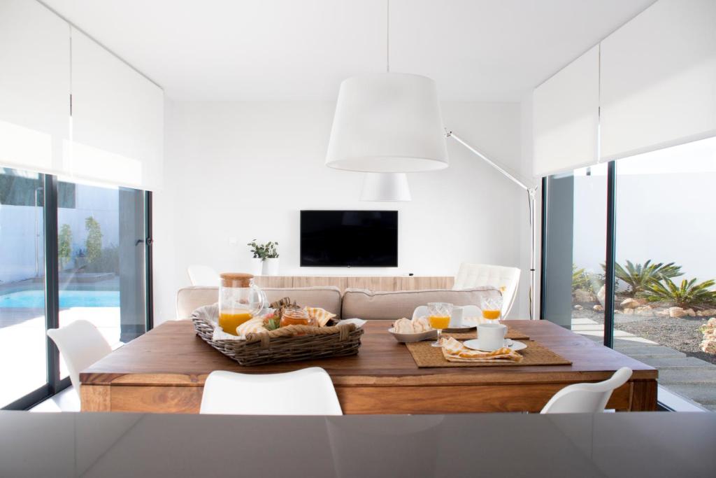 a living room with a table with food on it at Sunrise Chalet Casilla de Costa in La Oliva