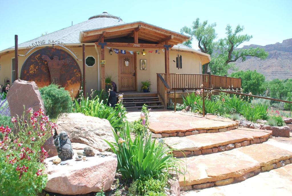 a house with a stone walkway leading to a front yard at Red Moon Lodge in Moab
