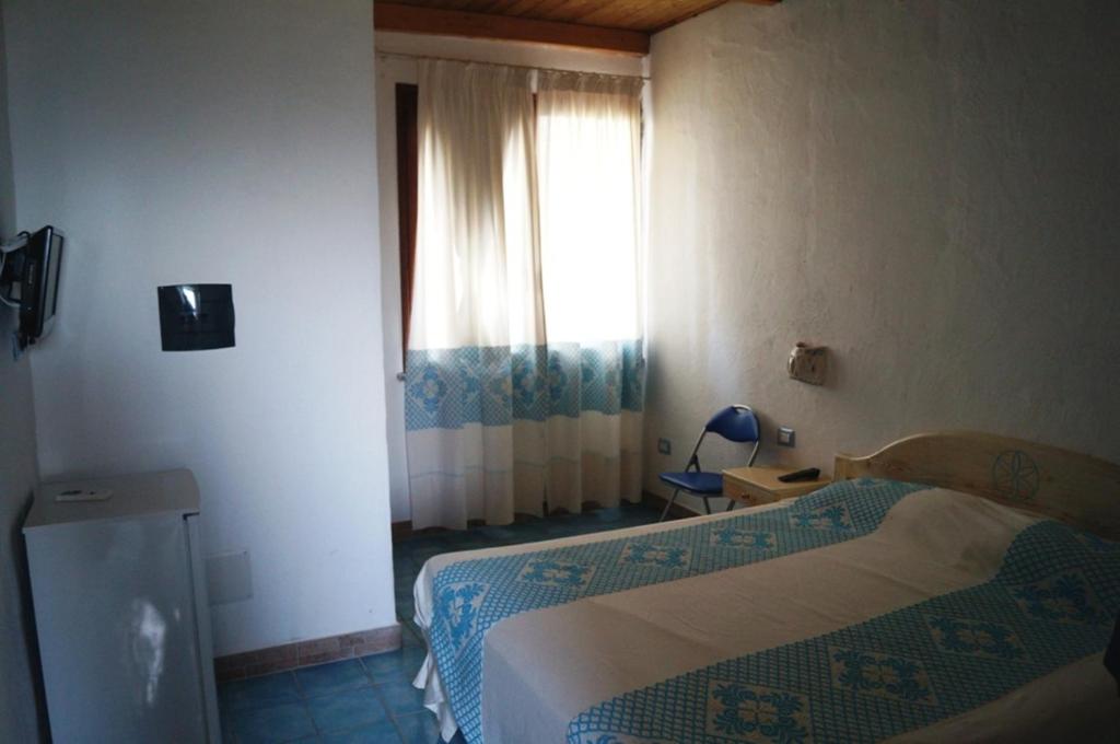 A bed or beds in a room at Agriturismo Irghitula
