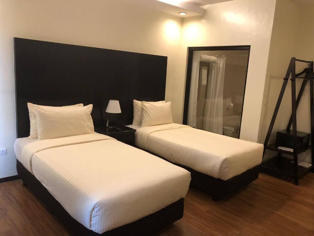 Postel nebo postele na pokoji v ubytování Piña Suites