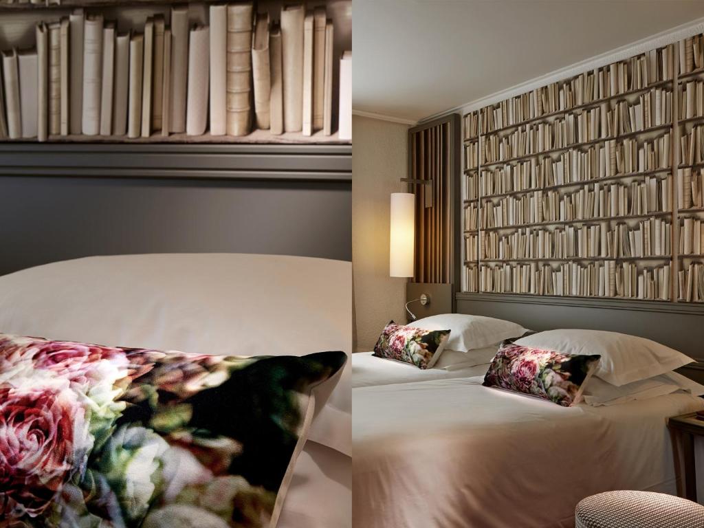a bedroom with two beds and a wall with books at Hotel America in Cannes