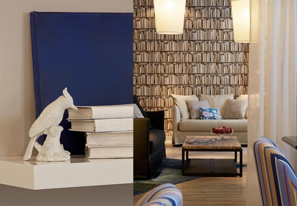 a living room with a couch and a table with books at Hotel America in Cannes