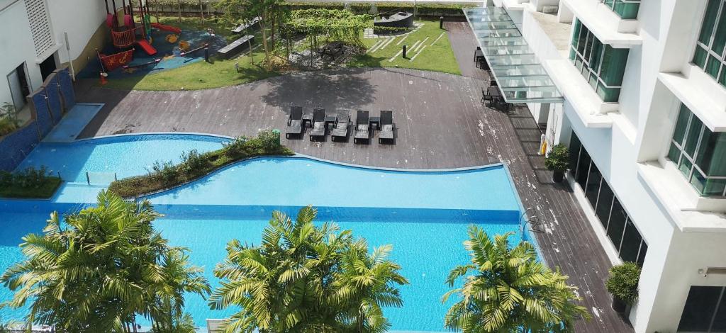 an overhead view of two swimming pools in a building at Aston Kiara Suites in Kuala Lumpur