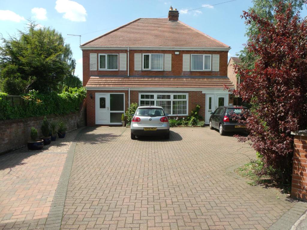 a house with two cars parked in a driveway at Acers Studio in Newark upon Trent