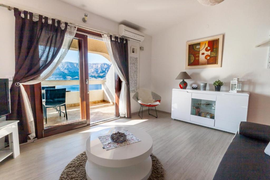 a living room with a large window and a couch at Lori in Baška