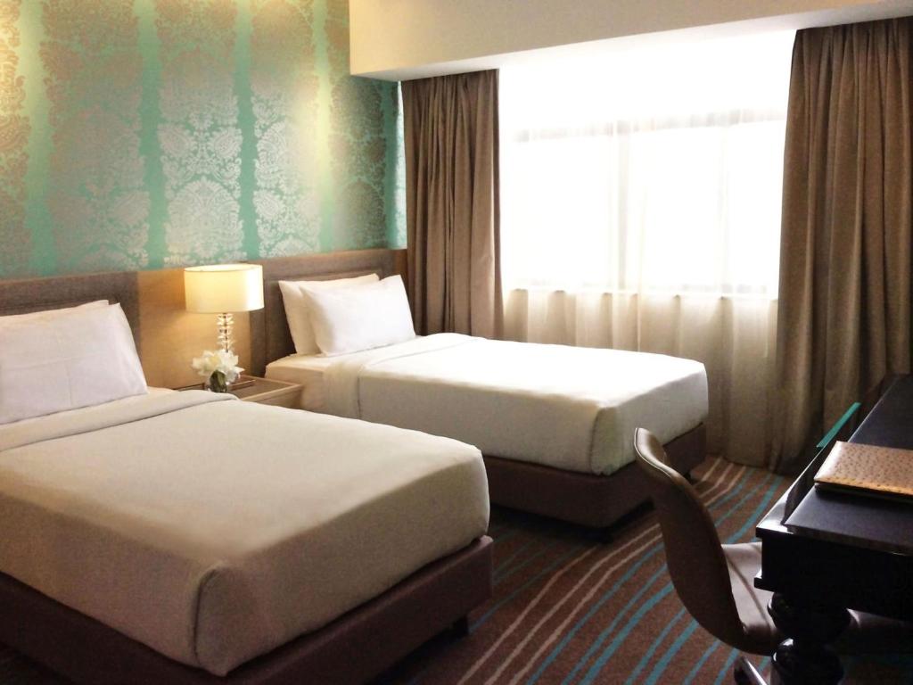 Postel nebo postele na pokoji v ubytování Cosmo Hotel Kuala Lumpur