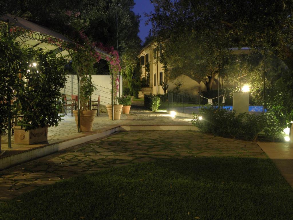 a patio at night with lights in a yard at Residence Torre Delle Viole in Marina di Camerota