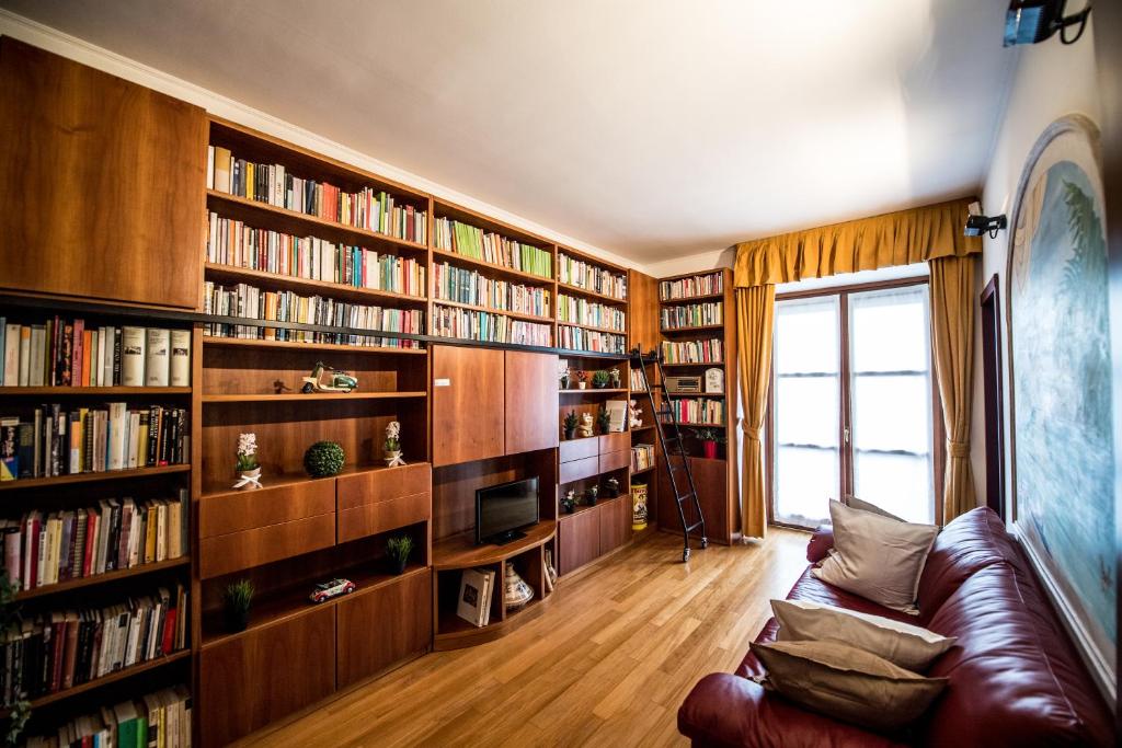 a living room with book shelves filled with books at Airguest Crocetta loft in Milan