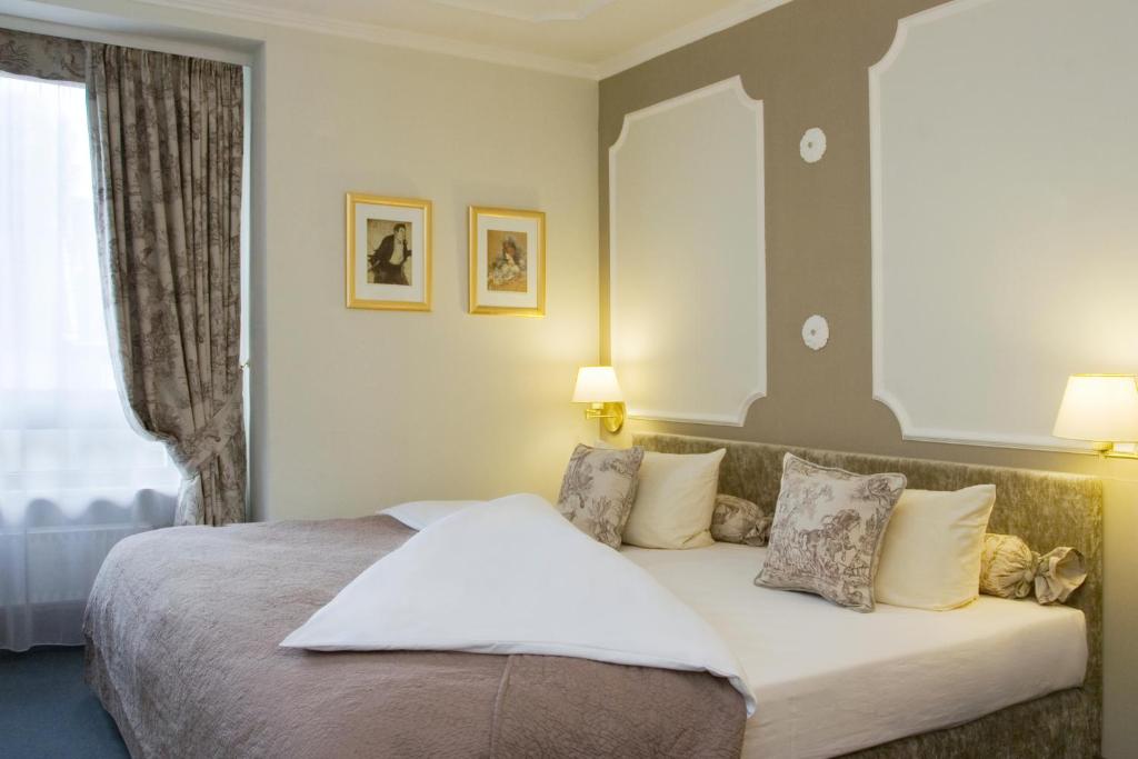 Кровать или кровати в номере Gildors Hotel Atmosphère