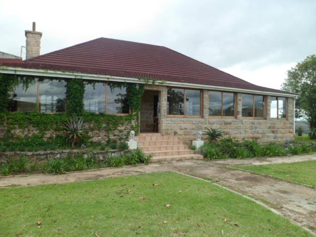 a brick house with a red roof at Thokazi Royal Lodge in Nongoma
