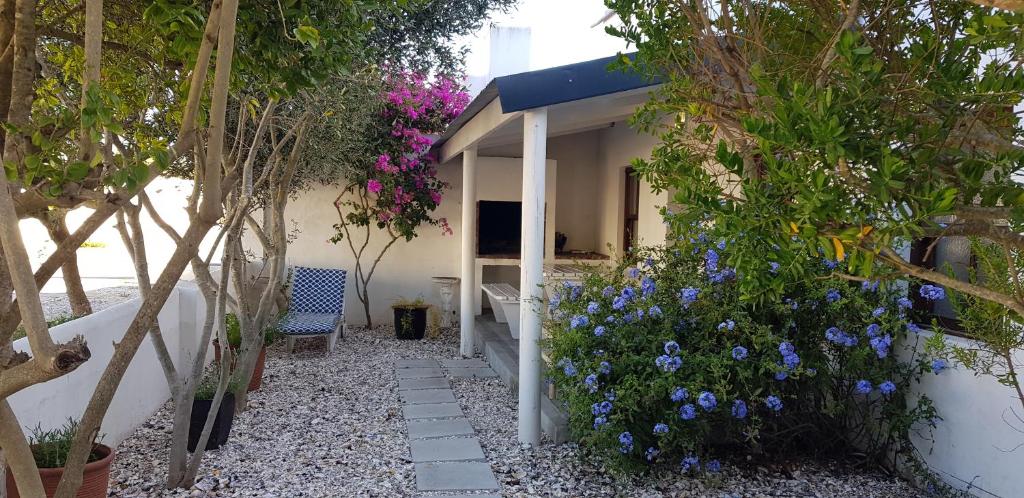 a garden with blue flowers on the side of a building at Paternoster Place in Paternoster