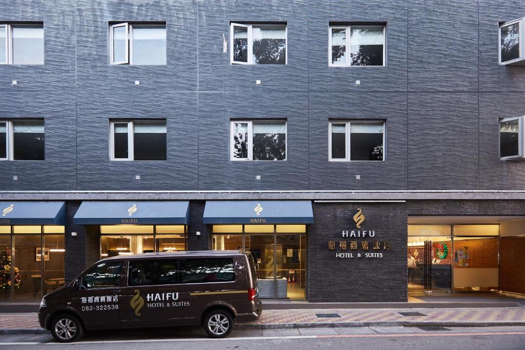 a black van parked in front of a building at Hai Fu Hotel & Suites in Jincheng