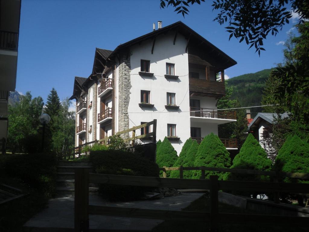 a large white building with a black roof at Pensione Bianca in Bardonecchia