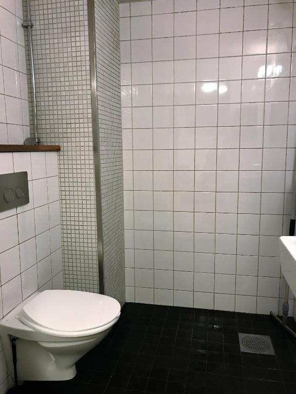 a bathroom with a toilet and a sink at Hostel Dalagatan in Stockholm