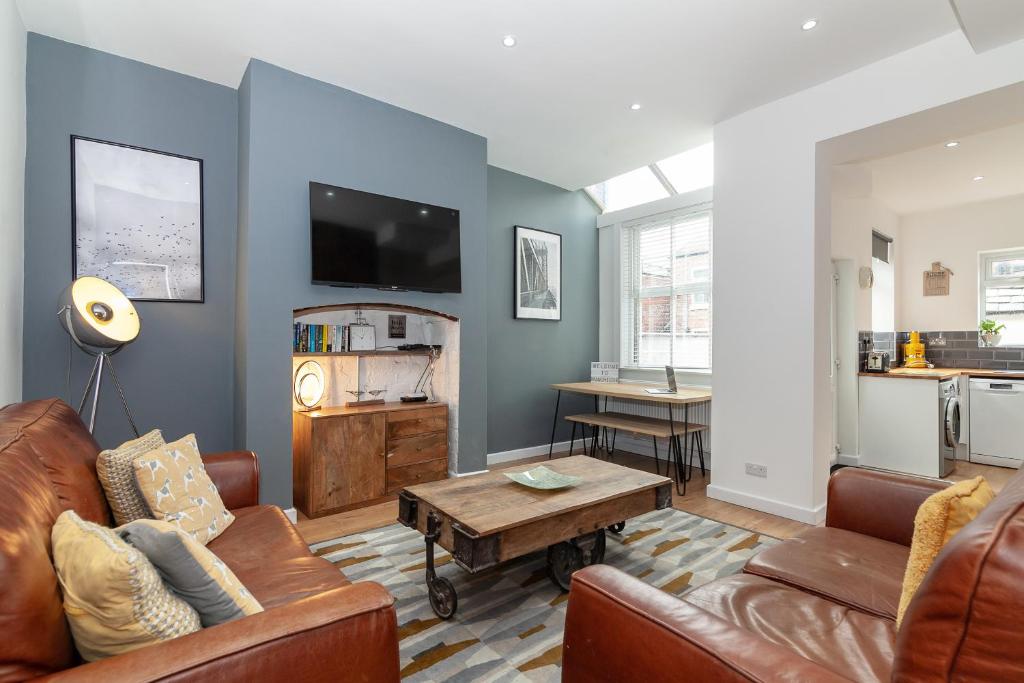 a living room with a couch and a table at Park House in Manchester