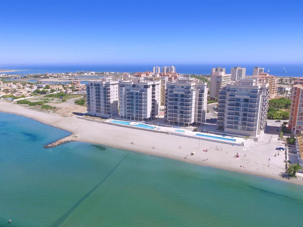 an aerial view of a beach with buildings and the ocean at La Manga Beach Club Apartments in La Manga del Mar Menor