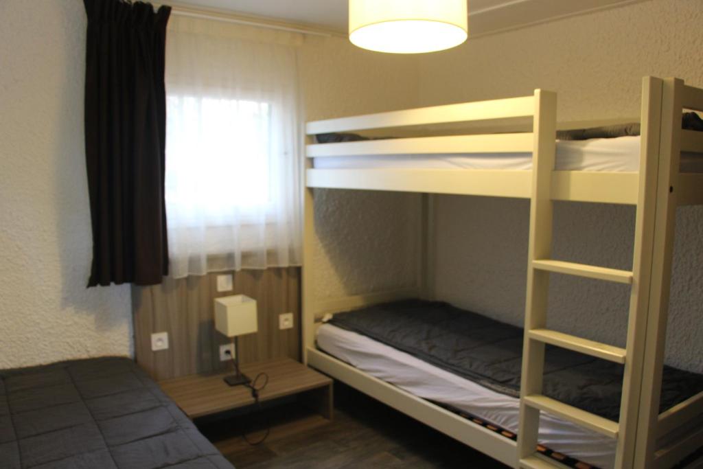 a room with two bunk beds and a window at VVF Lège Cap Ferret in Lège-Cap-Ferret